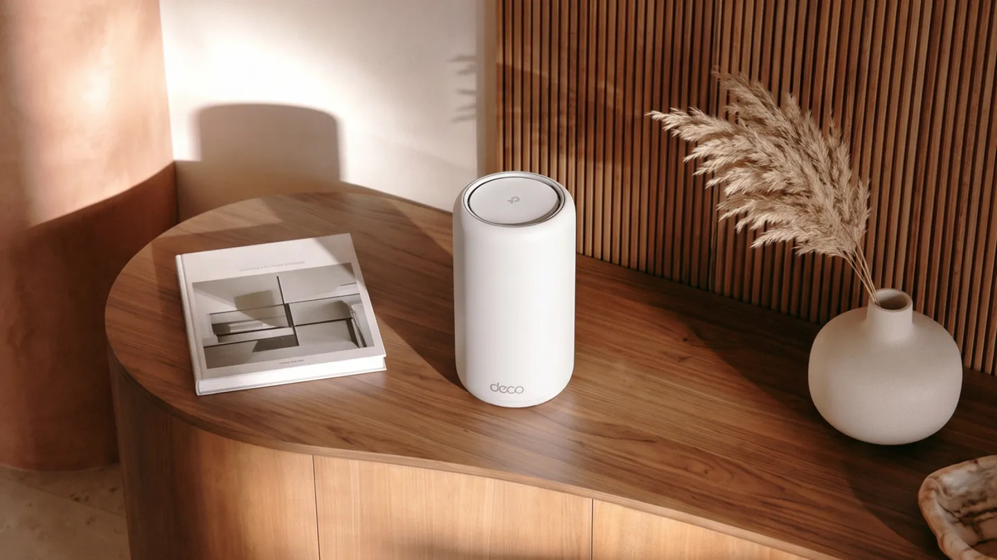 TP-Link Deco 8 Ultra mesh router unit placed on a wooden cabinet in a living room